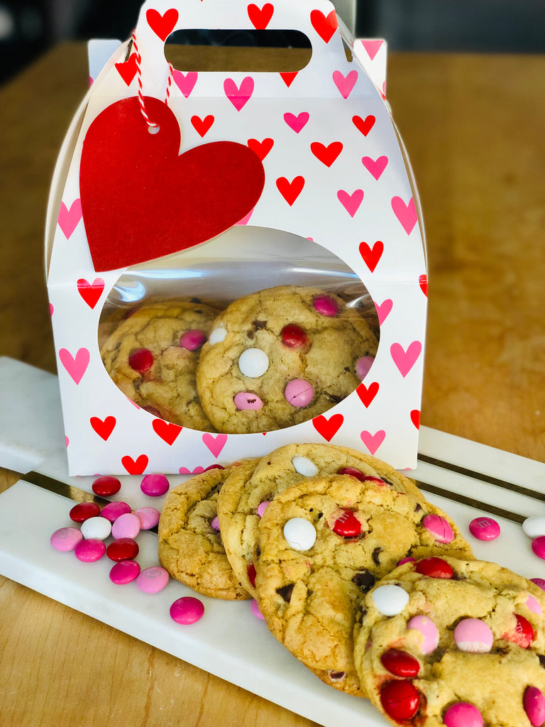 White box with red and pink hearts filled with M&M Cookies